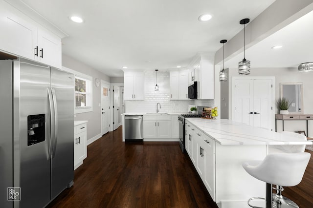 1166 S Highland Ave, Arlington Heights, IL 60005 - kitchen with stainless steel appliances, a sink, white cabinets, a peninsula, and backsplash