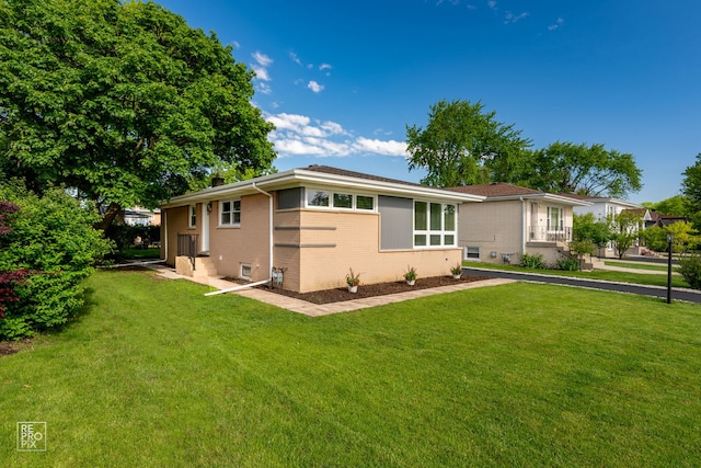1166 S Highland Ave, Arlington Heights, IL 60005 - view of front facade with brick siding, a front lawn, and a chimney