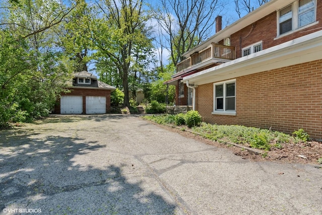 1005 Division St, Lisle, IL 60532 - view of side of property with brick siding, a garage, a chimney, and a balcony