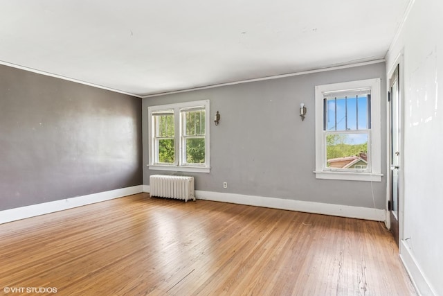 1005 Division St, Lisle, IL 60532 - spare room with radiator heating unit, hardwood / wood-style flooring, baseboards, and crown molding