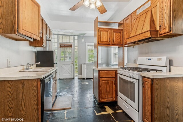 1005 Division St, Lisle, IL 60532 - kitchen featuring white gas range oven, a sink, light countertops, and dishwashing machine