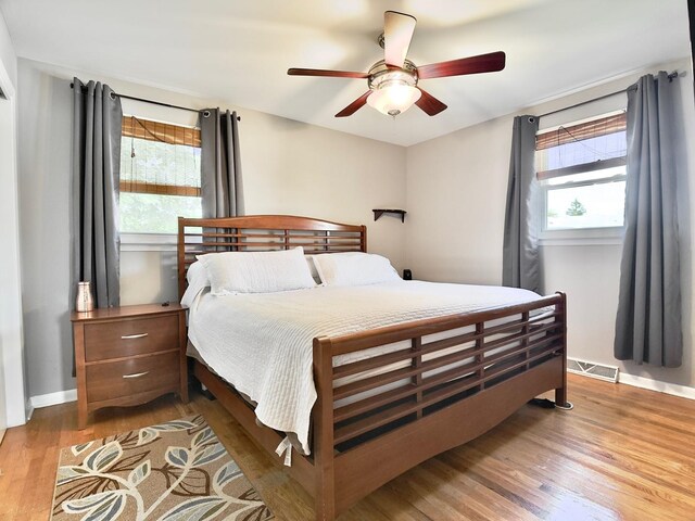 9113 Elm Cir, Hickory Hills, IL 60457 - bedroom featuring wood finished floors, multiple windows, baseboards, and ceiling fan