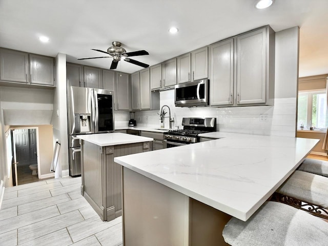 9113 Elm Cir, Hickory Hills, IL 60457 - kitchen with appliances with stainless steel finishes, gray cabinetry, a peninsula, and recessed lighting