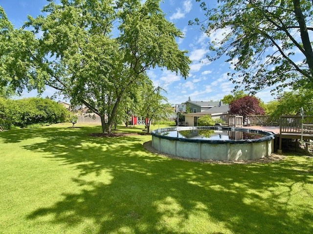 9113 Elm Cir, Hickory Hills, IL 60457 - view of green lawn with a wooden deck and a covered pool