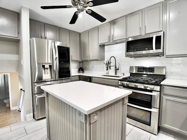 9113 Elm Cir, Hickory Hills, IL 60457 - kitchen featuring appliances with stainless steel finishes, gray cabinets, a sink, and backsplash