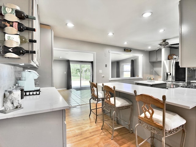 9113 Elm Cir, Hickory Hills, IL 60457 - kitchen featuring stainless steel fridge with ice dispenser, gray cabinetry, tasteful backsplash, open shelves, and recessed lighting