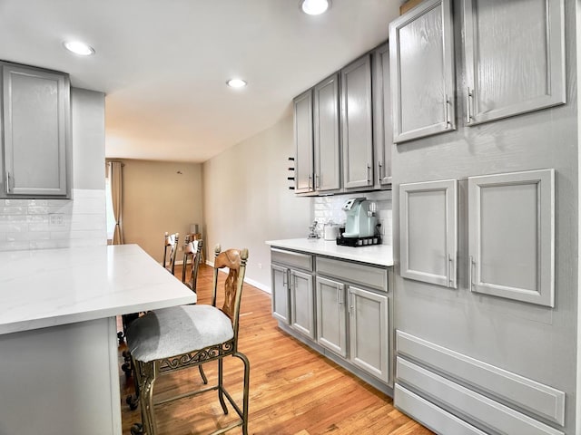 9113 Elm Cir, Hickory Hills, IL 60457 - kitchen with gray cabinetry, decorative backsplash, light wood-style flooring, baseboards, and recessed lighting