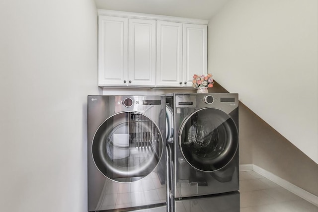 2013 Valor Ct, Glenview, IL 60026 - laundry room featuring washing machine and dryer, cabinet space, baseboards, and light tile patterned flooring