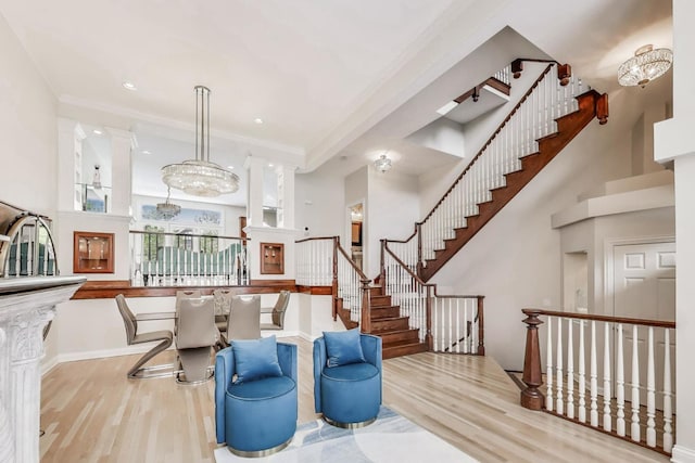 2013 Valor Ct, Glenview, IL 60026 - living room with wood finished floors, a high ceiling, crown molding, stairway, and baseboards