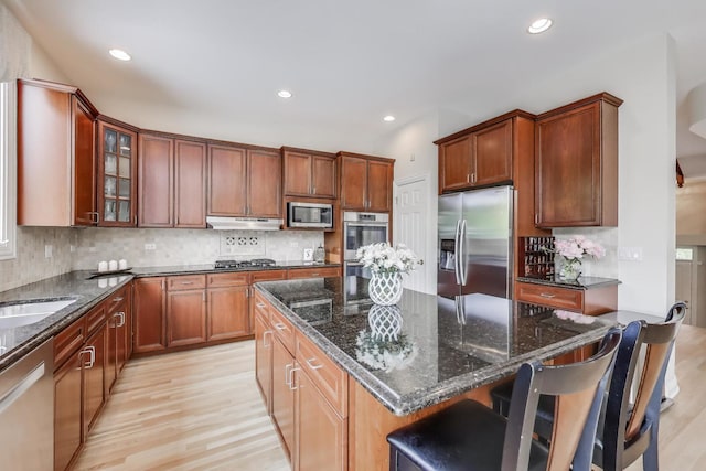 2013 Valor Ct, Glenview, IL 60026 - kitchen featuring stainless steel appliances, light wood-style floors, a center island, recessed lighting, and dark stone countertops