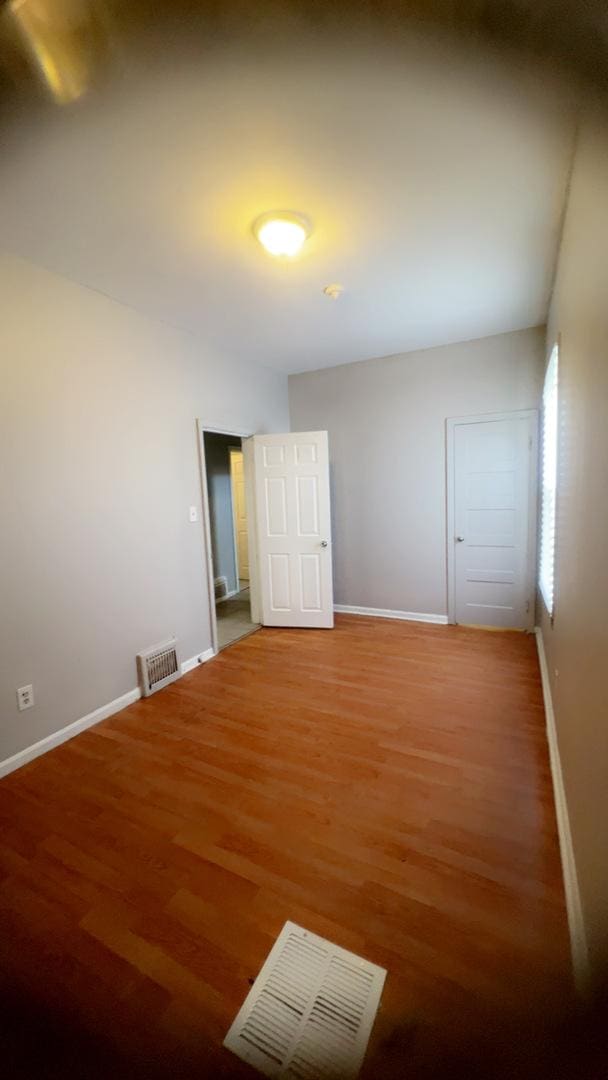 10643 S Calhoun Ave, Chicago, IL 60617 - spare room with light wood-type flooring and baseboards