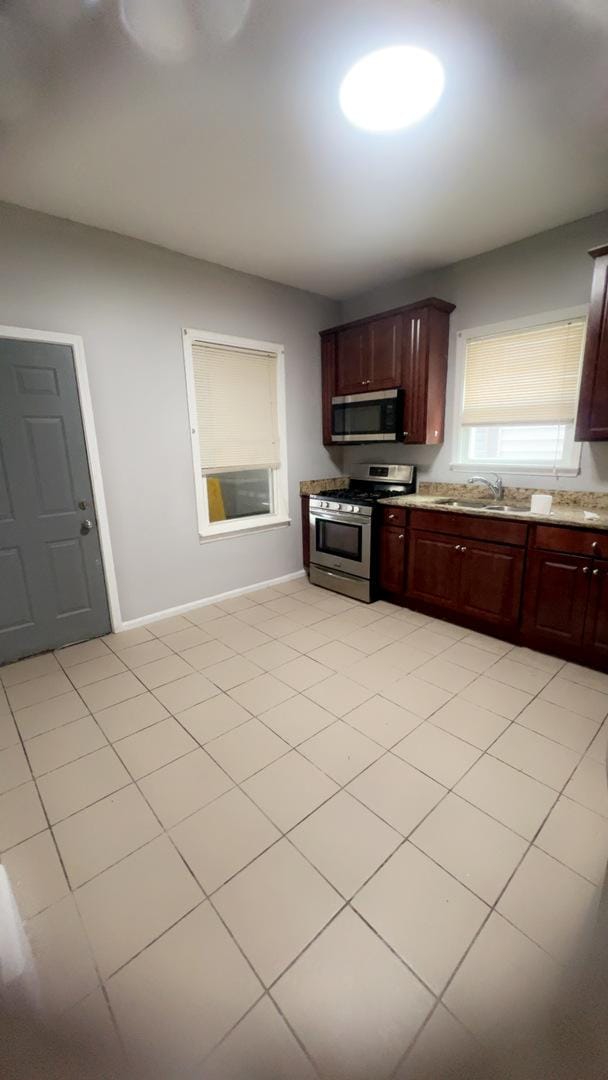 10643 S Calhoun Ave, Chicago, IL 60617 - kitchen featuring appliances with stainless steel finishes, a sink, and baseboards