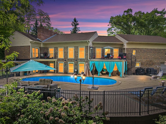 2010 Sleepy Hollow Rd, Sleepy Hollow, IL 60118 - back of property at dusk with a fenced backyard, a balcony, and a patio