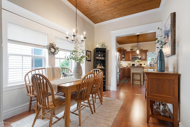 17918 Ridgewood Ave, Lansing, IL 60438 - dining space featuring wood ceiling, a chandelier, light wood-type flooring, ornamental molding, and baseboards