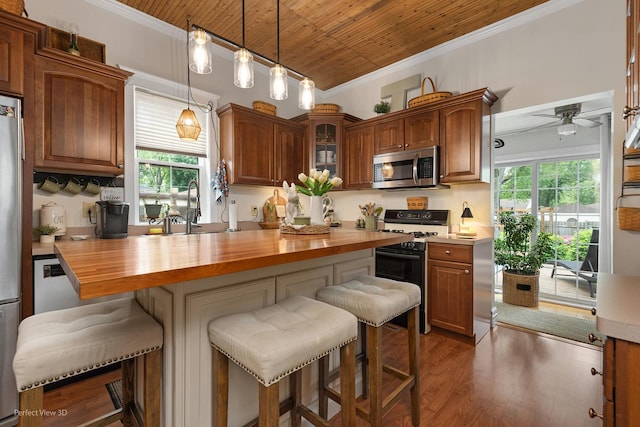 17918 Ridgewood Ave, Lansing, IL 60438 - kitchen featuring stainless steel microwave, range with gas cooktop, butcher block counters, crown molding, and a sink