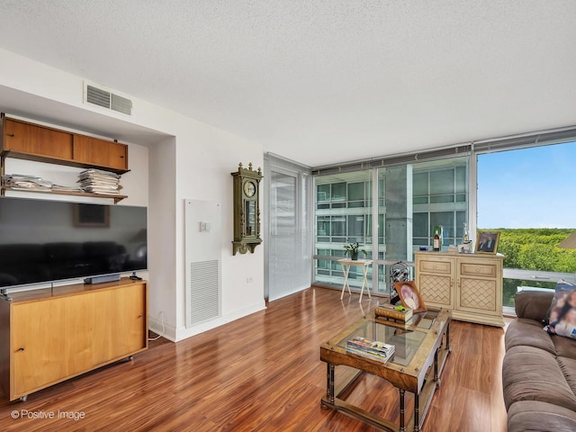 9715 Woods Dr Unit 1104, Skokie, IL 60077 - living area with wood finished floors, floor to ceiling windows, a textured ceiling, and baseboards