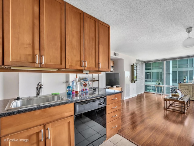 9715 Woods Dr Unit 1104, Skokie, IL 60077 - kitchen with dishwasher, a sink, brown cabinetry, a textured ceiling, and wood finished floors