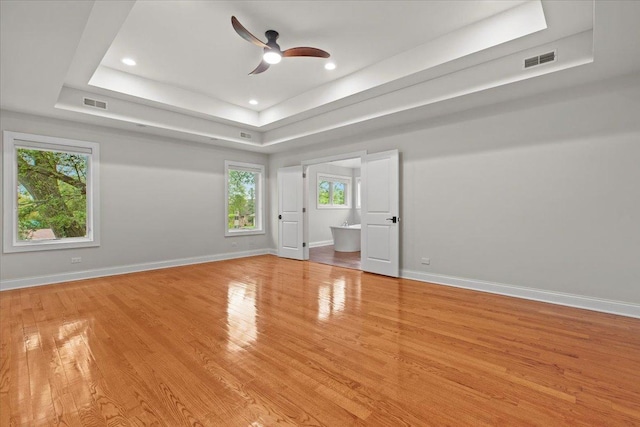 3 Crestview Ter, Buffalo Grove, IL 60089 - unfurnished room featuring a tray ceiling, light wood-style floors, ceiling fan, recessed lighting, and baseboards