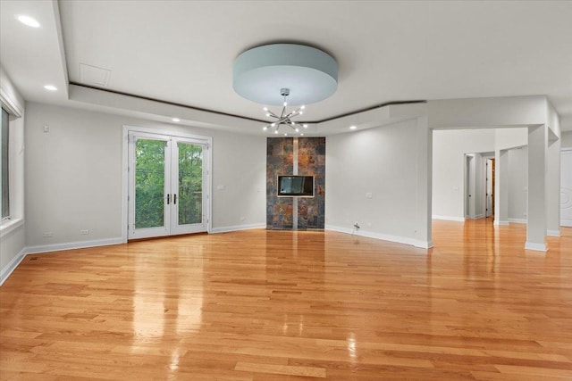 3 Crestview Ter, Buffalo Grove, IL 60089 - unfurnished living room with recessed lighting, light wood-style flooring, baseboards, a chandelier, and a premium fireplace