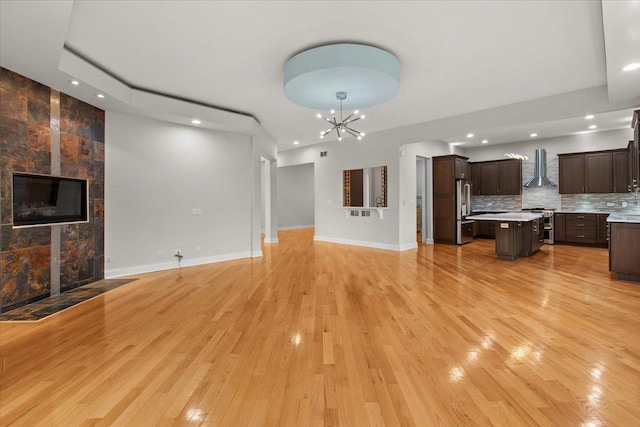 3 Crestview Ter, Buffalo Grove, IL 60089 - unfurnished living room featuring light wood-style floors, a chandelier, a fireplace, baseboards, and recessed lighting