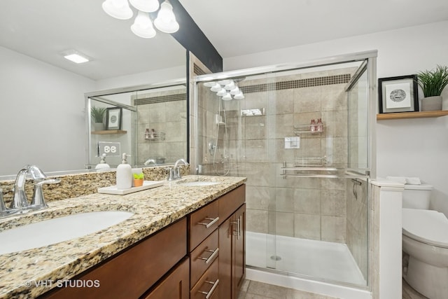 1263 Evergreen Ave, Des Plaines, IL 60016 - bathroom featuring toilet, double vanity, a shower stall, and tile patterned flooring
