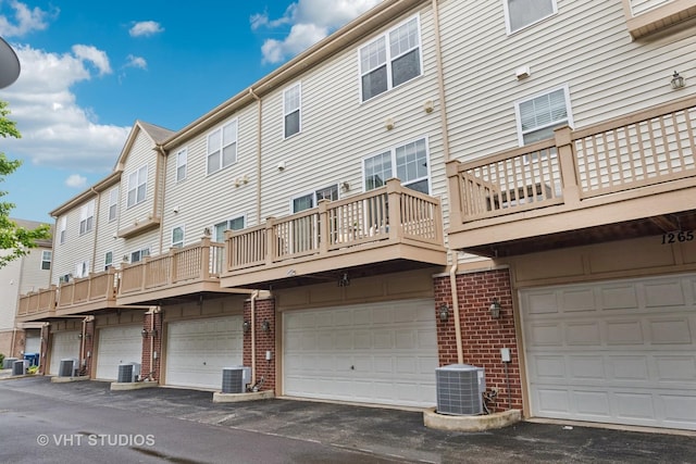 1263 Evergreen Ave, Des Plaines, IL 60016 - back of house with central air condition unit, brick siding, a balcony, and a garage