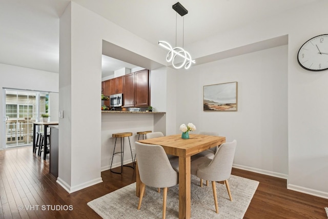 1263 Evergreen Ave, Des Plaines, IL 60016 - dining space with dark wood-style floors, baseboards, and a chandelier