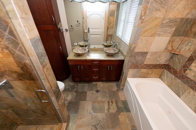 2612 W Diversey Ave Unit 101, Chicago, IL 60647 - full bathroom featuring a bath, double vanity, stone finish floors, and a shower stall