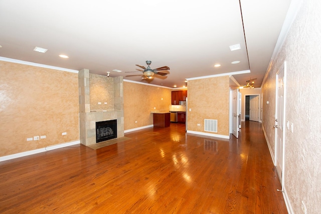 2612 W Diversey Ave Unit 101, Chicago, IL 60647 - unfurnished living room featuring wood finished floors, ornamental molding, ceiling fan, recessed lighting, and a fireplace