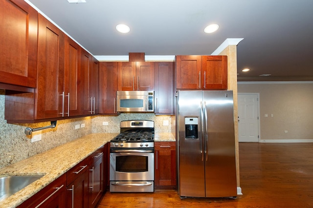 2612 W Diversey Ave Unit 101, Chicago, IL 60647 - kitchen featuring stainless steel appliances, crown molding, dark wood-style floors, backsplash, and light stone counters