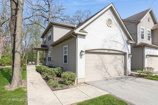 2831 Granite Ct, Crystal Lake, IL 60012 - view of side of home with asphalt driveway, brick siding, and an attached garage