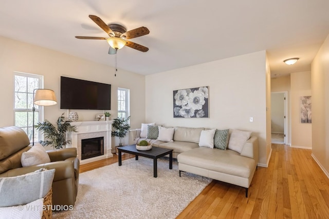 2831 Granite Ct, Crystal Lake, IL 60012 - living area with ceiling fan, light wood-style flooring, baseboards, and a glass covered fireplace