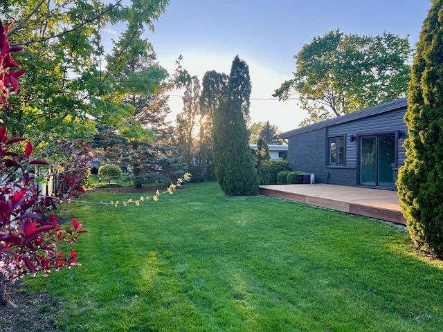7841 W Argyle St, Norridge, IL 60706 - view of green lawn featuring a wooden deck and central AC