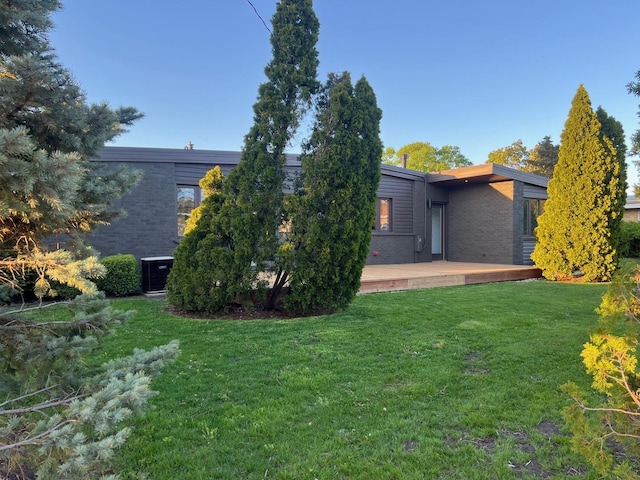 7841 W Argyle St, Norridge, IL 60706 - view of grassy yard with cooling unit and a deck