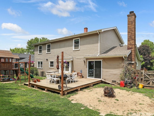 5501 Abbey Dr, Mchenry, IL 60050 - back of property featuring an outdoor fire pit, a chimney, a playground, a wooden deck, and outdoor dining area