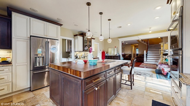 8N594 S Mclean Blvd, South Elgin, IL 60177 - kitchen with appliances with stainless steel finishes, wood counters, decorative backsplash, a kitchen island, and recessed lighting