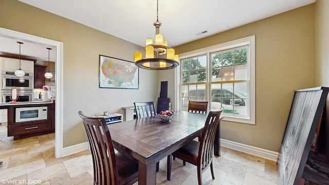 8N594 S Mclean Blvd, South Elgin, IL 60177 - dining area with a chandelier and stone tile floors
