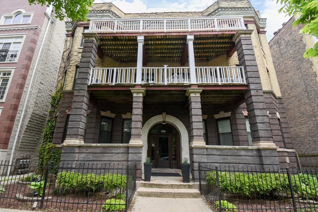 4419 N Racine Ave Unit 1N, Chicago, IL 60640 - view of front of property with a fenced front yard and a balcony