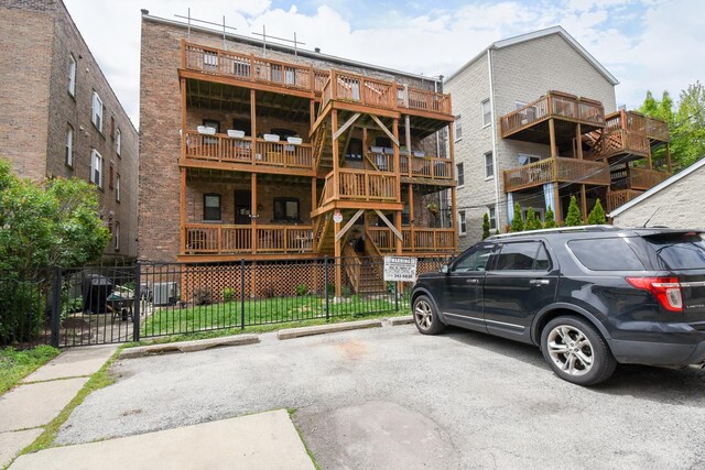 4419 N Racine Ave Unit 1N, Chicago, IL 60640 - view of apartment building / complex featuring uncovered parking