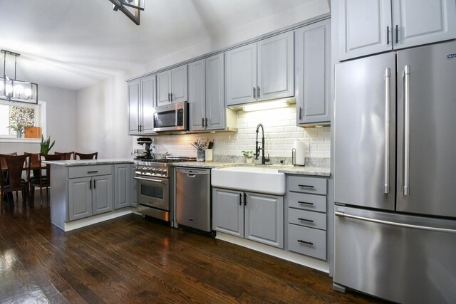 4419 N Racine Ave Unit 1N, Chicago, IL 60640 - kitchen featuring premium appliances, gray cabinets, a sink, and a peninsula