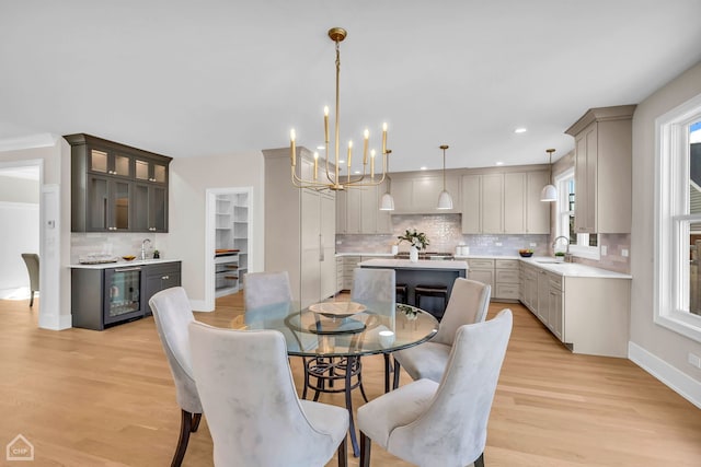 4920 Stonewall Ave, Downers Grove, IL 60515 - dining room featuring wine cooler, a chandelier, healthy amount of natural light, light wood finished floors, and recessed lighting
