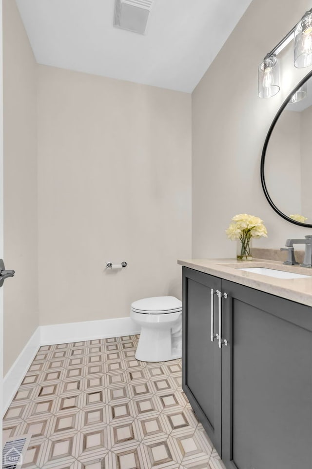 4920 Stonewall Ave, Downers Grove, IL 60515 - bathroom with vanity, toilet, tile patterned floors, and baseboards