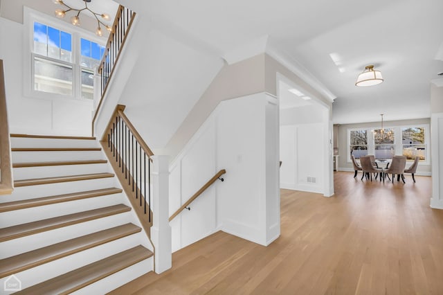 4920 Stonewall Ave, Downers Grove, IL 60515 - stairs featuring a chandelier, wood finished floors, and baseboards