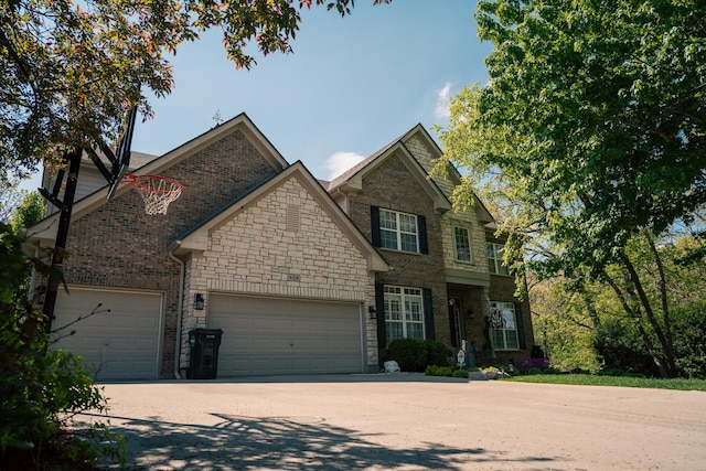 406 Elderberry Ln, Streamwood, IL 60107 - view of front of home with a garage, driveway, brick siding, and stone siding