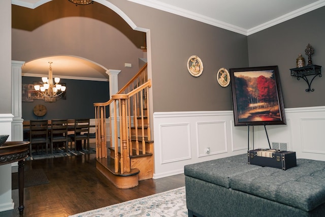 406 Elderberry Ln, Streamwood, IL 60107 - living room with ornate columns, a chandelier, wood finished floors, arched walkways, and a wainscoted wall