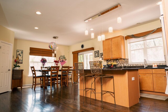 406 Elderberry Ln, Streamwood, IL 60107 - kitchen featuring a kitchen bar, recessed lighting, dark wood-style floors, pendant lighting, and a sink