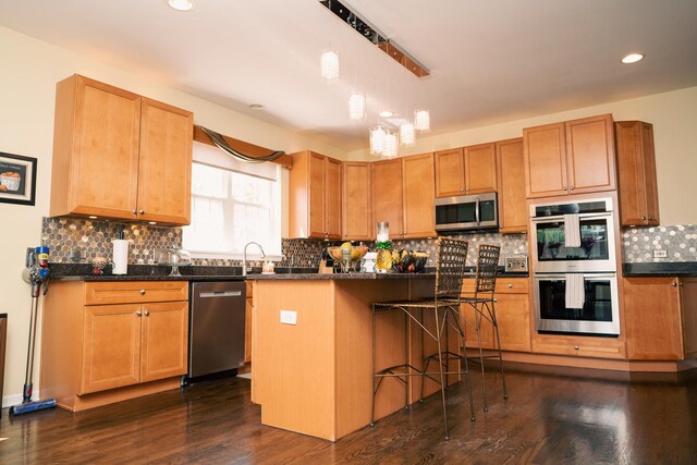 406 Elderberry Ln, Streamwood, IL 60107 - kitchen featuring stainless steel appliances, backsplash, dark wood-style floors, a kitchen breakfast bar, and recessed lighting