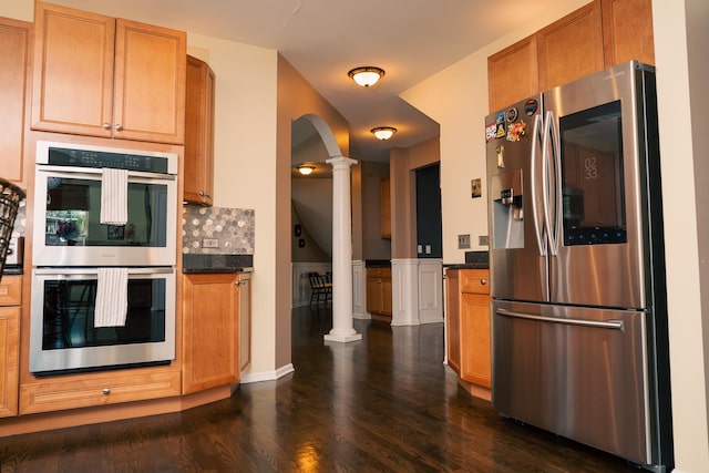 406 Elderberry Ln, Streamwood, IL 60107 - kitchen featuring appliances with stainless steel finishes, ornate columns, dark wood finished floors, arched walkways, and backsplash