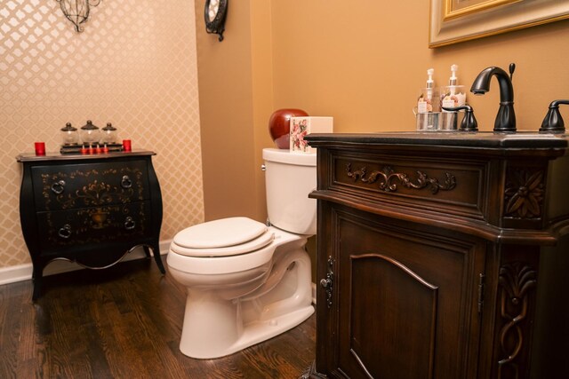 406 Elderberry Ln, Streamwood, IL 60107 - half bathroom with wood finished floors, baseboards, toilet, vanity, and wallpapered walls