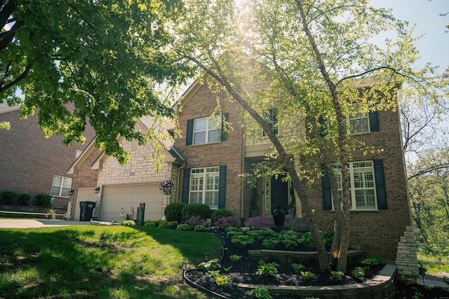 406 Elderberry Ln, Streamwood, IL 60107 - traditional-style house with brick siding, a garage, and a front lawn